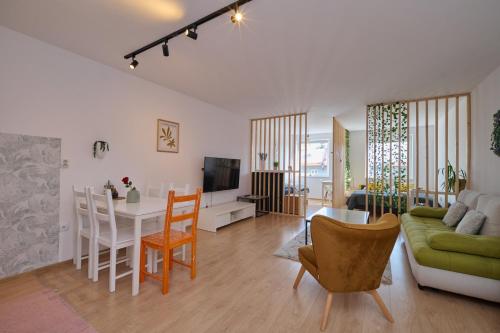 a living room with a couch and a table with chairs at Central Apartments in Martin