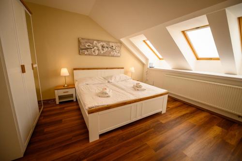 a bedroom with a bed in a room with a window at Apartmán U krále - 2 in Jičín