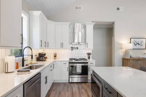 a white kitchen with a sink and a stove at New Home, Dock, Kayaks, Game Room, Water Views in Winchester