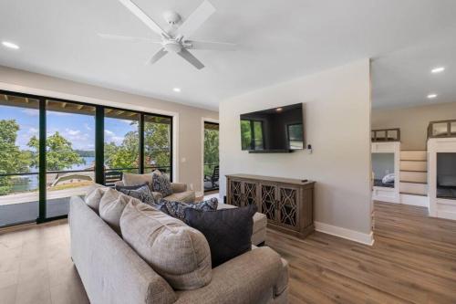 a living room with a couch and a ceiling fan at New Home, Dock, Kayaks, Game Room, Water Views in Winchester