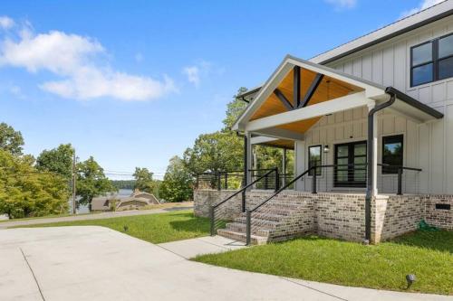 a home with a roof extension on a building at New Home, Dock, Kayaks, Game Room, Water Views in Winchester