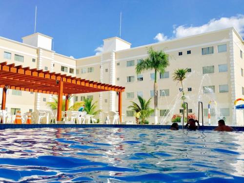 a pool at a hotel with people in the water at Encontro das Águas Thermas resort in Caldas Novas