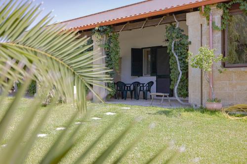 a house with chairs and a table in the yard at Agriturismo Le Tagliate in Uggiano la Chiesa