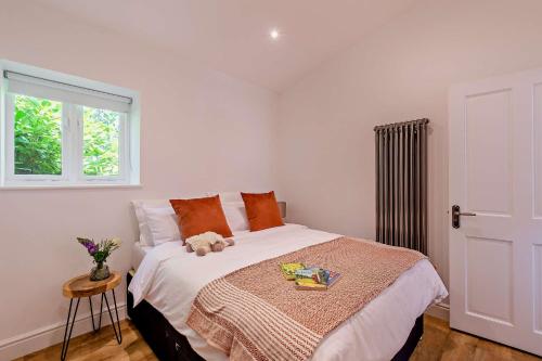 a bedroom with a bed with a teddy bear on it at The Willows by Bloom Stays in Ash