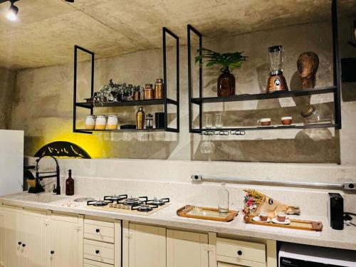 a kitchen with a stove and shelves on the wall at Santa Cabana - Rio de Janeiro in Rio de Janeiro