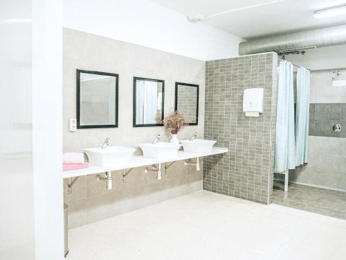y baño con 3 lavabos y ducha. en ALBERGUE ALOXA HOSTEL en Pontevedra