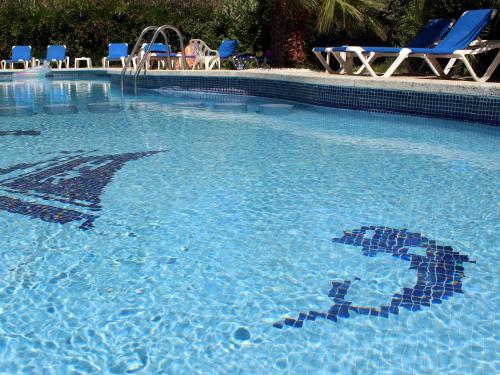 a swimming pool with a teddy bear in the water at Rocatel in Canet de Mar