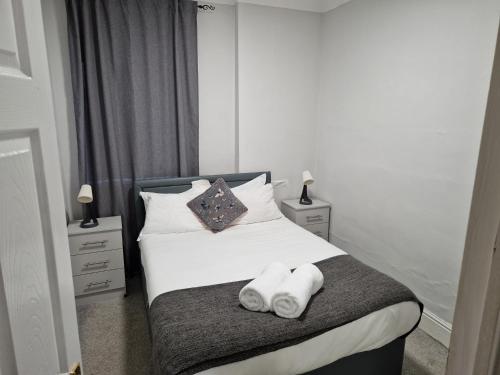 a bedroom with a bed with towels on it at Birtley's Amethyst, 3 bedroom Apt ,sleeps 6 Guest in Birtley