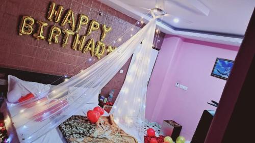 a room with a happy birthday sign on the wall at HOTEL HAYAT RESIDENCY in Jaipur
