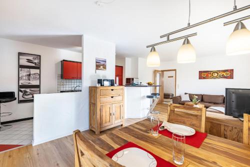 a living room with a kitchen and a living room with a couch at Südalb in Albstadt