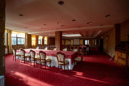 a dining room with a table and chairs in it at House of Dracula Hotel in Poiana Brasov
