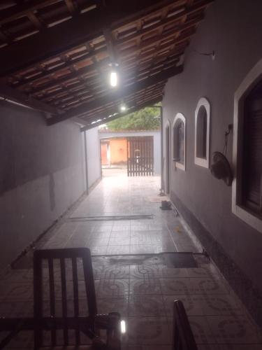 an empty hallway with a light at the end of a building at Casa perto da praia mobiliada in Itanhaém