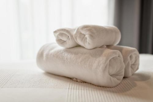 two towels stacked on top of each other on a bed at ALEGRIA Colonial Mar in Roquetas de Mar