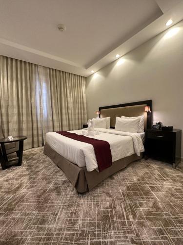 a large bedroom with a large bed and a window at Al Joud Hotel Makkah in Makkah