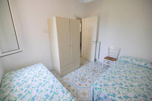 a bedroom with a bed and a cabinet and a chair at Agriturismo Le Tagliate in Uggiano la Chiesa