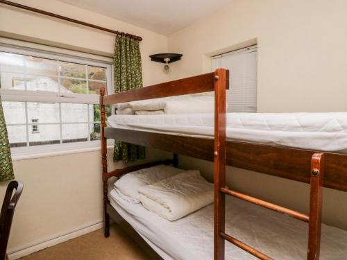 two bunk beds in a room with a window at Thwaite How in Keswick