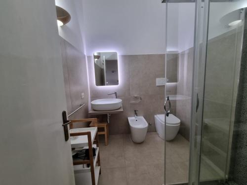 a bathroom with a toilet and a sink and a shower at Agriturismo Le Tagliate in Uggiano la Chiesa