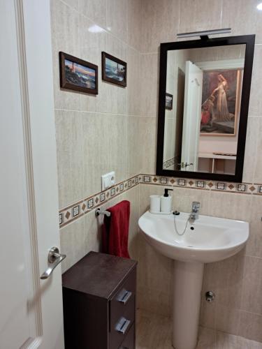a bathroom with a sink and a mirror at Centrico, Parking incluido in Jaén