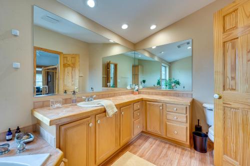 a bathroom with a sink and a large mirror at Rustic Ward Retreat with Deck and Mountain Views! in Ward