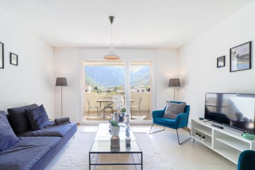 a living room with a couch and a tv at Nice apartment ideally located in Martigny in Martigny-Ville