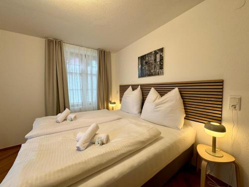 a bedroom with two beds with towels on them at Ferienzauber 1897 in Dornbirn