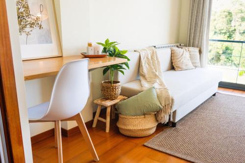 a living room with a white couch and a table at Magníficos Dias Atlânticos in Moledo