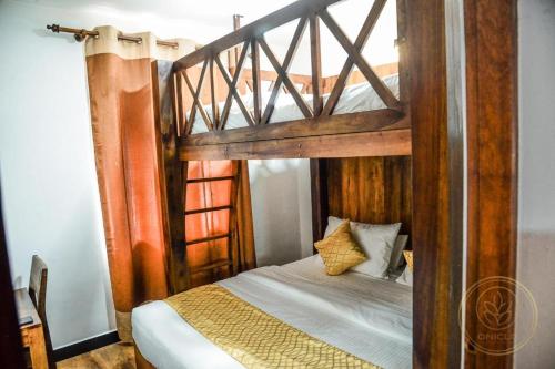 a bedroom with a wooden bunk bed with white sheets at Kapri Luxury Apartment in Nuwara Eliya