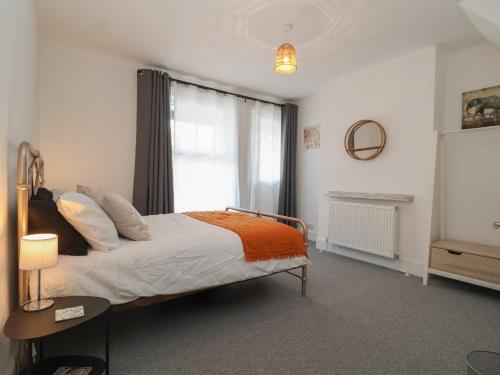 a bedroom with a bed and a window at 11a Manning Road in Felixstowe