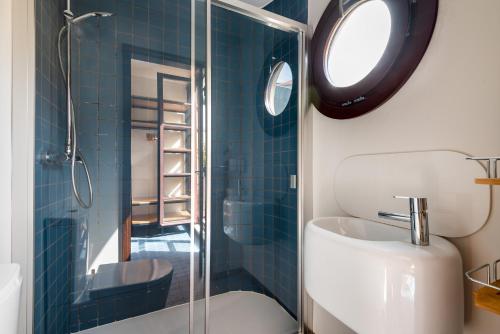 a bathroom with a toilet and a sink and a mirror at Rivoli Apartments in Porto