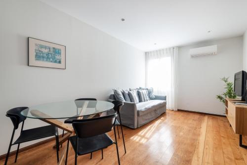 a living room with a glass table and a couch at Rivoli Apartments in Porto