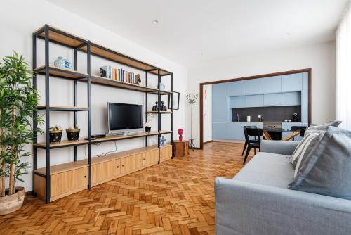 a living room with a couch and a tv at Rivoli Apartments in Porto