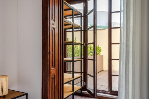 a glass door with a view of a balcony at Rivoli Apartments in Porto