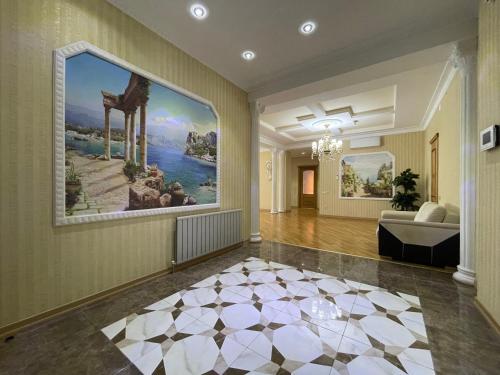 a living room with a large painting on the wall at Megafun Sea View in Baku