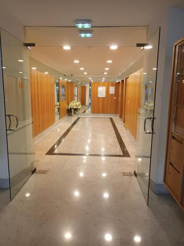 a hallway of a building with glass doors and a floor at Attico Victoria Palace suggestivo e spettacolare in Menton