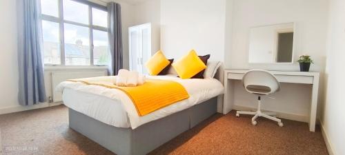 a bedroom with a bed and a desk and a chair at Park View Garden in London