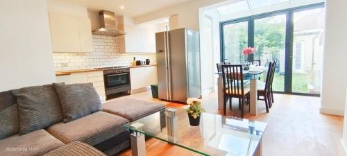 a living room with a couch and a table at Park View Garden in London