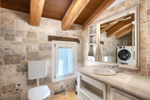 a bathroom with a sink and a mirror at Rustic villa Krug with panorama view in Buje in Bibali