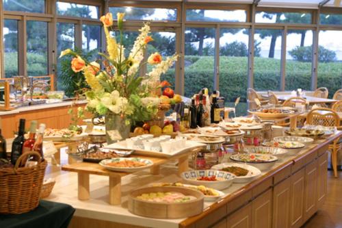 a long table filled with food and bottles of wine at Okura Hotel Marugame in Marugame