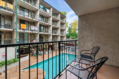a balcony with a swimming pool and two chairs at Suite Serenity of Gatlinburg*indoor & outdoor pool in Gatlinburg