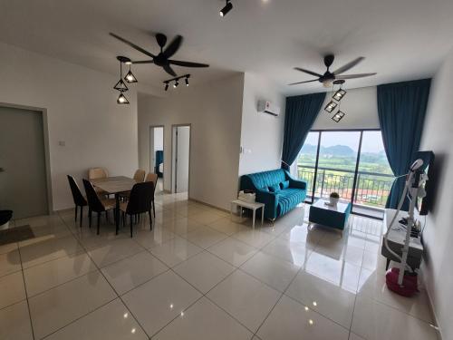 a living room with a blue couch and a table at Horizon Premium Suite - Ipoh in Ipoh