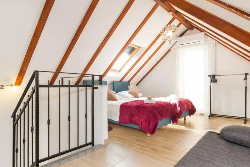 a bedroom with a bed with a red blanket at Peruzovic Rooms 2 in Split