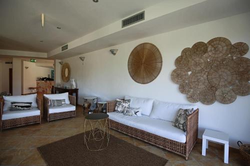 a living room with a couch and a table at La Smeraldina Resort in Santa Teresa Gallura