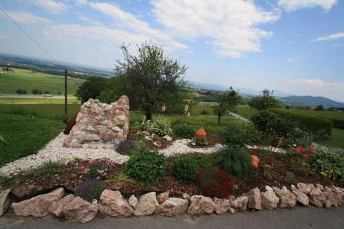 a garden with flowers and rocks in a yard at Bernerhof Ferienwohnungen Schmuck in Teisendorf