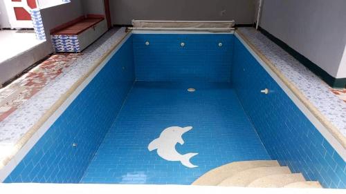 a swimming pool with a dolphin painted on the floor at One bedroom appartement with shared pool enclosed garden and wifi at M'bour 2 km away from the beach in Mbour