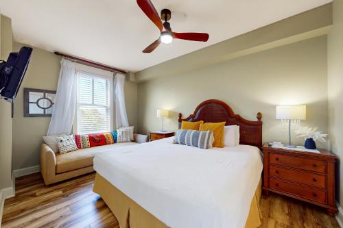 a bedroom with a bed and a couch at Grand Sandestin 2422 in Destin