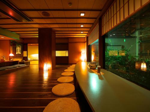 a lobby with a row of mats on the floor at Musashino Bekkan in Hakone