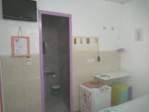 a small bathroom with a sink and a toilet at Tubarao Branco Suites Central Area in Itacaré
