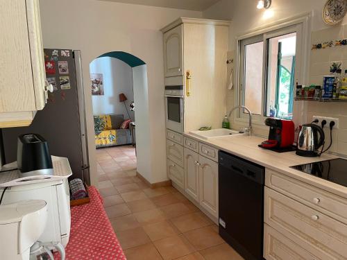 a kitchen with a sink and a counter at La Bastide Dambrine in Sanary-sur-Mer