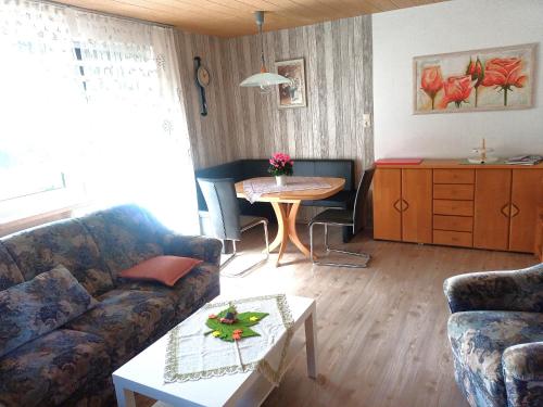 a living room with a couch and a table at Haus Rosenbühl in Warmensteinach