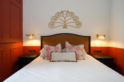 a bedroom with a white bed with pillows on it at Malta Luxe Guest Suite Central Location in Mosta